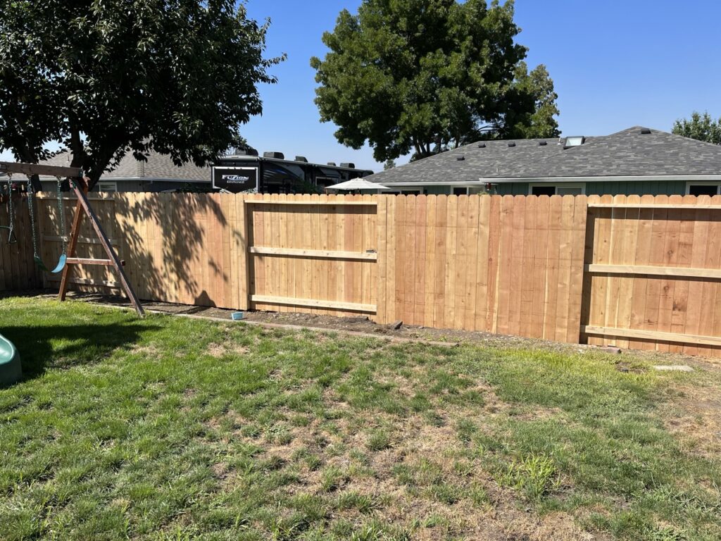 Expertly-constructed cedar fencing along a property line.