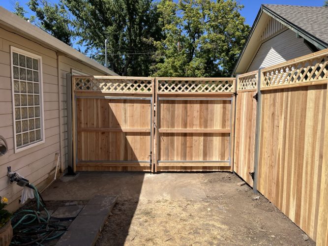 A beautiful cedar fence with a latticed top for a residential yard.